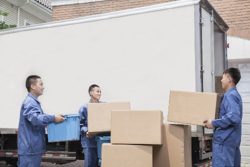 Man with van loading furniture in Kensington street