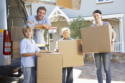 Professional movers loading household items from a Kensington property